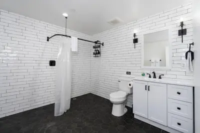 a white bathroom with a toilet and a sink at Kinslee Suite at The Four Daughters Inn in Oakhurst