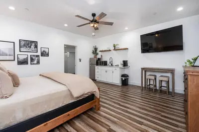 a bedroom with a bed and a ceiling fan at Kinslee Suite at The Four Daughters Inn in Oakhurst