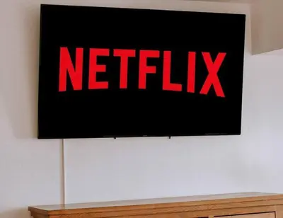 a screen with a netflix sign on a wall at Kinslee Suite at The Four Daughters Inn in Oakhurst