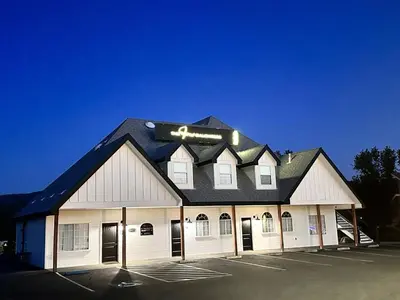 a large white building with a black roof at Ryann Suite at The Four Daughters Inn in Oakhurst