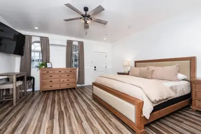 a bedroom with a bed and a ceiling fan at Ryann Suite at The Four Daughters Inn in Oakhurst