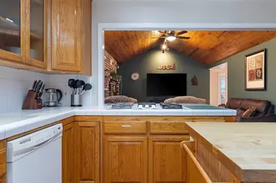 a kitchen with a stove and a tv in it at Harmony Home- EV Charger in Oakhurst