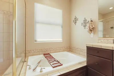 a bathroom with a tub and a shower and a sink at Oasis on the vine - Custom Luxury Resort Amenities in Lodi