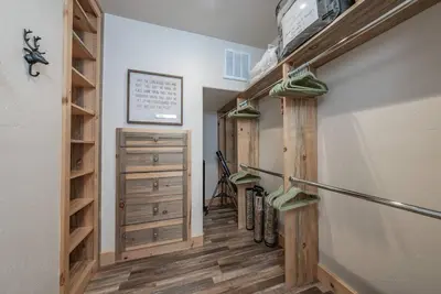 a walk in closet with wooden shelves and wooden floors at Multi-Family Villa-private spa waterfall in Shaver Lake