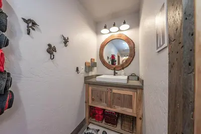 a bathroom with a sink and a mirror at Multi-Family Villa-private spa waterfall in Shaver Lake
