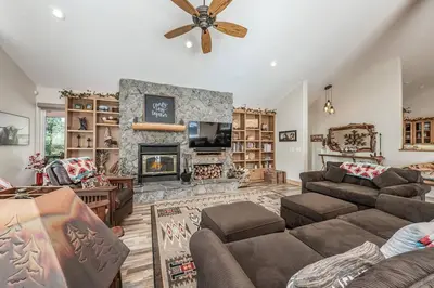 a living room with a couch and a fireplace at Multi-Family Villa-private spa waterfall in Shaver Lake