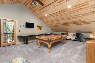 a living room with a pool table and a tv at Lazy Bear Lodge Rustic Luxe Villa with spa & gameroom in Shaver Lake