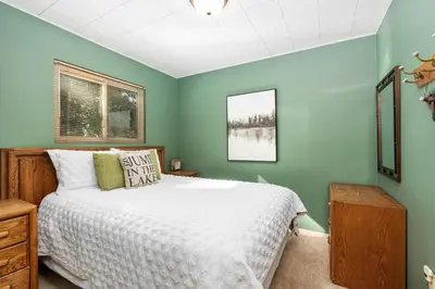a bedroom with a bed and green walls at Smoke Tree-Newly Updated Family Retreat in Shaver Lake