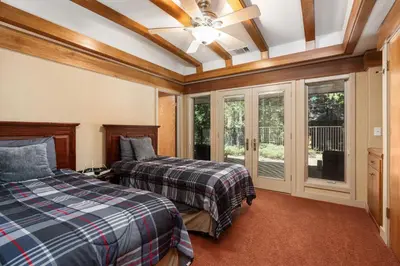 a bedroom with two beds and a ceiling fan at Single level Family cabin-Fenced in yard for pets & kids in Shaver Lake