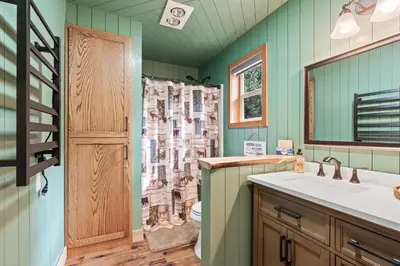 a bathroom with a toilet and a sink and a shower at Cedar Horn- Serene Family Shaver Retreat in Shaver Lake