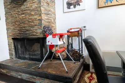 two chairs sitting in front of a fireplace at Kamp Kokanee-Updated Condo Near Spa Sauna in Shaver Lake