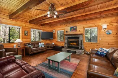 a living room with leather furniture and a fireplace at Black Diamond-Family Pet Friendly & Near China Peak in Big Creek