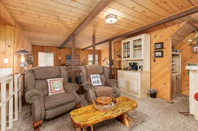 a living room with two chairs and a table at Wyldwood-Family Friendly-LOFT & BAR in Shaver Lake
