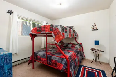 a bedroom with a red bunk bed in a room at Happy Bear- Family & Pet Friendly in Shaver Lake