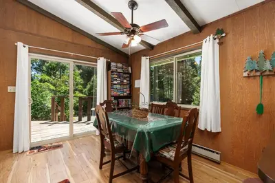 a dining room with a table and a ceiling fan at Happy Bear- Family & Pet Friendly in Shaver Lake