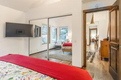 a bedroom with a red bed and a mirror at Snowcreek V 870 in Mammoth Lakes