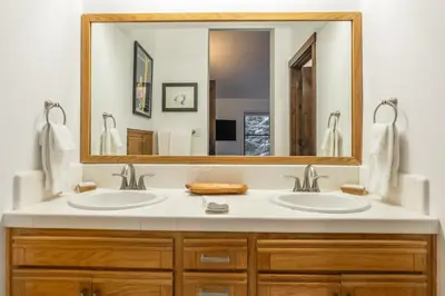 a bathroom with two sinks and a large mirror at Snowcreek V 870 in Mammoth Lakes