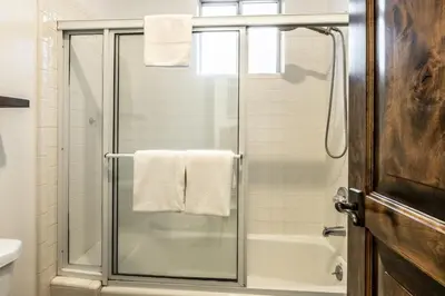 a bathroom with a shower with a glass door at Snowcreek V 870 in Mammoth Lakes