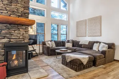 a living room with a couch and a fireplace at Snowcreek V 870 in Mammoth Lakes
