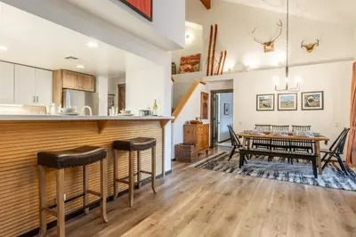 a kitchen and dining room with a table and chairs at Snowcreek V 870 in Mammoth Lakes