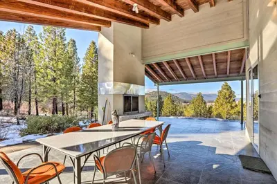 an outdoor kitchen with a table and chairs on a patio at A Quiet Escape in Truckee