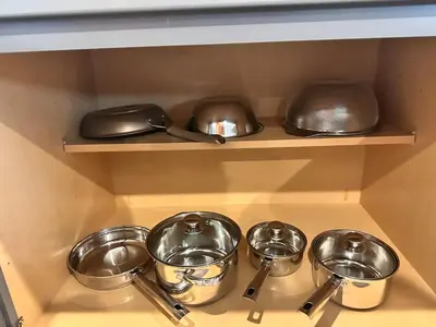 a row of pots and pans on a shelf at A modern retreat and Gateway to Yosemite in Merced
