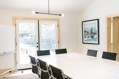 a conference room with a white table and chairs at The Coachman Hotel in South Lake Tahoe