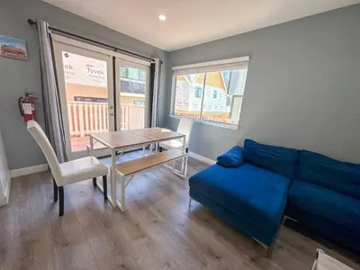 a living room with a blue couch and a table at Charming Lake Tahoe Getaway 30 Plus Days Bookings Only Accepted in Zephyr Cove