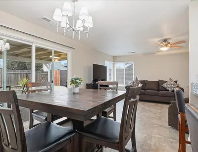 a dining room and living room with a table and chairs at Casa Cortez C in Visalia