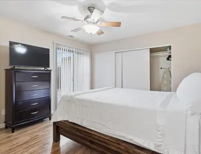 a bedroom with a bed and a ceiling fan at Casa Cortez C in Visalia