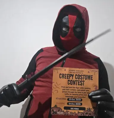 a person in a spider man costume holding a box at Gen apt in Roseville