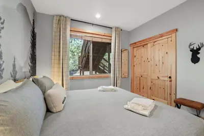 a bedroom with a bed with two towels on it at Evergreen Getaway Pet Friendly in SLT w Hot Tub in South Lake Tahoe