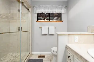 a bathroom with a shower and a toilet at Apple Blossom Lodge-Family Friendly Cabin in Shaver Lake