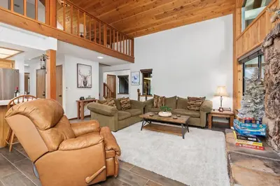 a living room with a couch and a table at Kokanee Hideaway-Family Friendly 5BR Epic Game Room in Shaver Lake