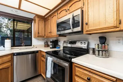 a kitchen with a stove and a microwave at Kokanee Hideaway-Family Friendly 5BR Epic Game Room in Shaver Lake