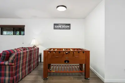 a living room with a couch and a table at Kokanee Hideaway-Family Friendly 5BR Epic Game Room in Shaver Lake