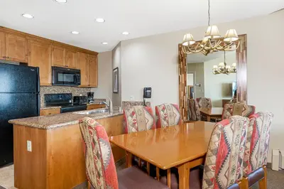 a kitchen and dining room with a wooden table and chairs at Enjoy the Ridge Tahoe Two-Bedroom Lock-Off for a family of 6 in Stateline