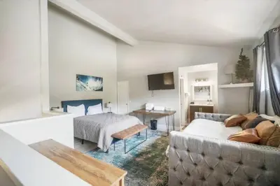 a living room with a couch and a bed at Guest Favorite Spacious Remodeled 2 Bdrm 2 Ba Mountain Views in Mammoth Lakes