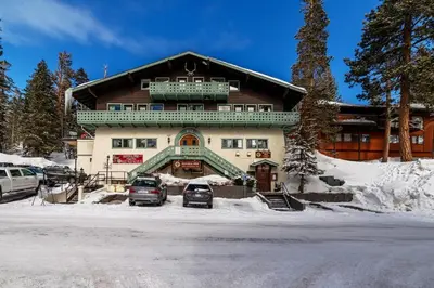 a large building with cars parked in front of it at Guest Favorite Spacious Remodeled 2 Bdrm 2 Ba Mountain Views in Mammoth Lakes