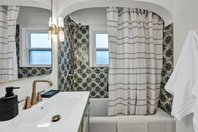 a bathroom with a sink and a shower curtain at New-Near Midtown-HotTub-Firepit-Arlington Manor in Reno
