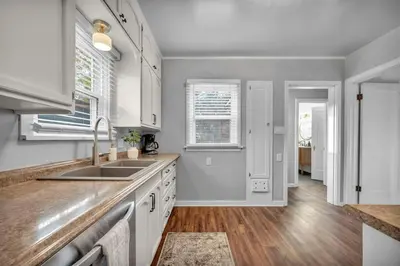 a kitchen with white cabinets and a sink at New-Near Midtown-HotTub-Firepit-Arlington Manor in Reno