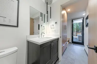 a bathroom with a sink and a mirror at Aerial Grace Lakeside – 4BR Luxury w/ Private Beach, Pier, Sauna in Tahoma