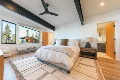 a bedroom with a bed and a large window at Aerial Grace Lakeside – 4BR Luxury w/ Private Beach, Pier, Sauna in Tahoma