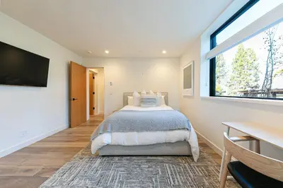 a bedroom with a bed and a window and a desk at Aerial Grace Lakeside – 4BR Luxury w/ Private Beach, Pier, Sauna in Tahoma