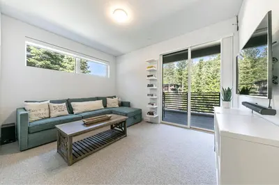 a living room with a couch and a table at Starfall Run at Palisades by Tahoe Getaways - Luxury 3BR w Ski Shuttle, A/C & Bonus Room! in Alpine Meadows
