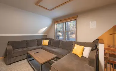 a living room with a couch and a table at The Heavenly Foothills For 4 in South Lake Tahoe