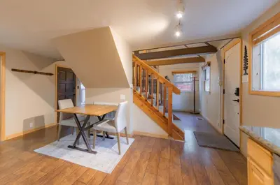 a dining room with a table and a staircase at The Heavenly Foothills For 4 in South Lake Tahoe
