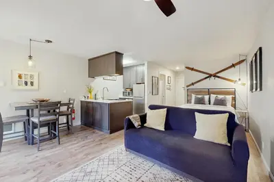 a living room and kitchen with a blue couch at Cozy Kings Run Condo in Tahoe Vista