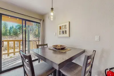 a dining room with a wooden table and chairs at Cozy Kings Run Condo in Tahoe Vista