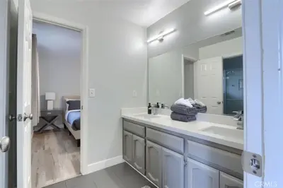a bathroom with a sink and a large mirror at Amazing Views Hot Tub-Games-Fire pit 6BR Sleeps 20 in Oakhurst